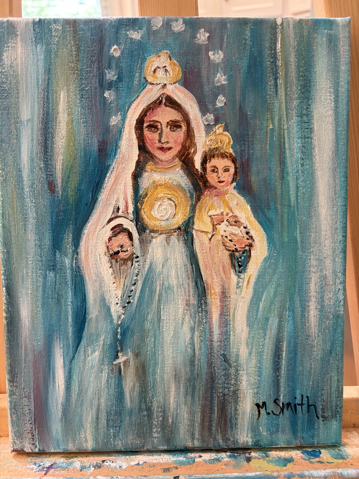 Painting of the Virgin Mary holding the Christ Child against a blue background